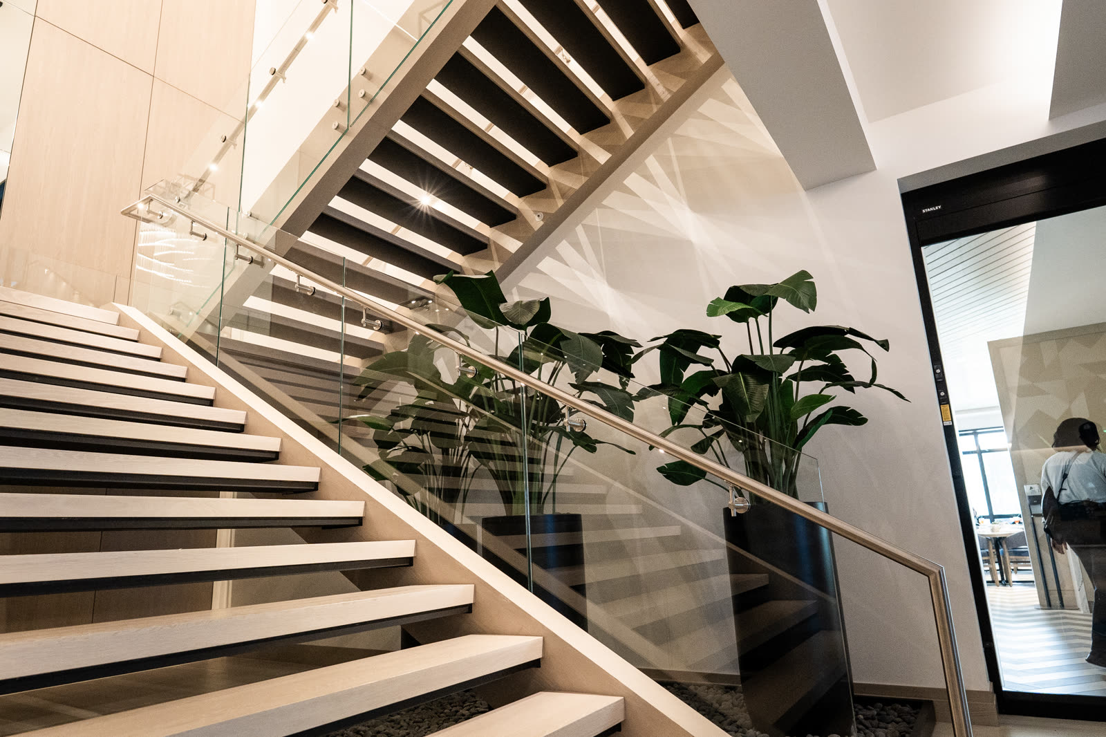 Interior monument stair at Frenchman's Creek with Brisk M6 standoff-mounted glass railing
